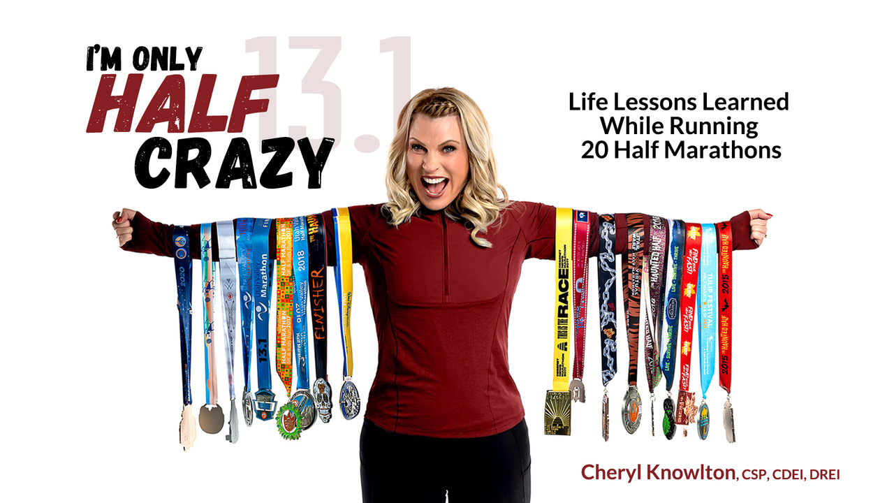 Cheryl Knowlton holding her awards for running 20 half marathons